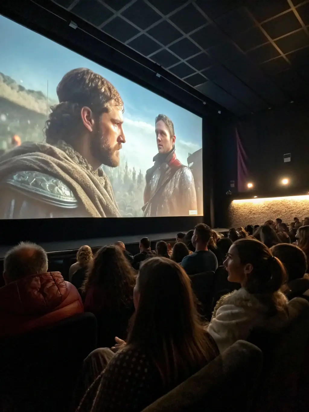 A photo of a restored historical film being screened at a community event, with people of all ages watching and engaging with the content.